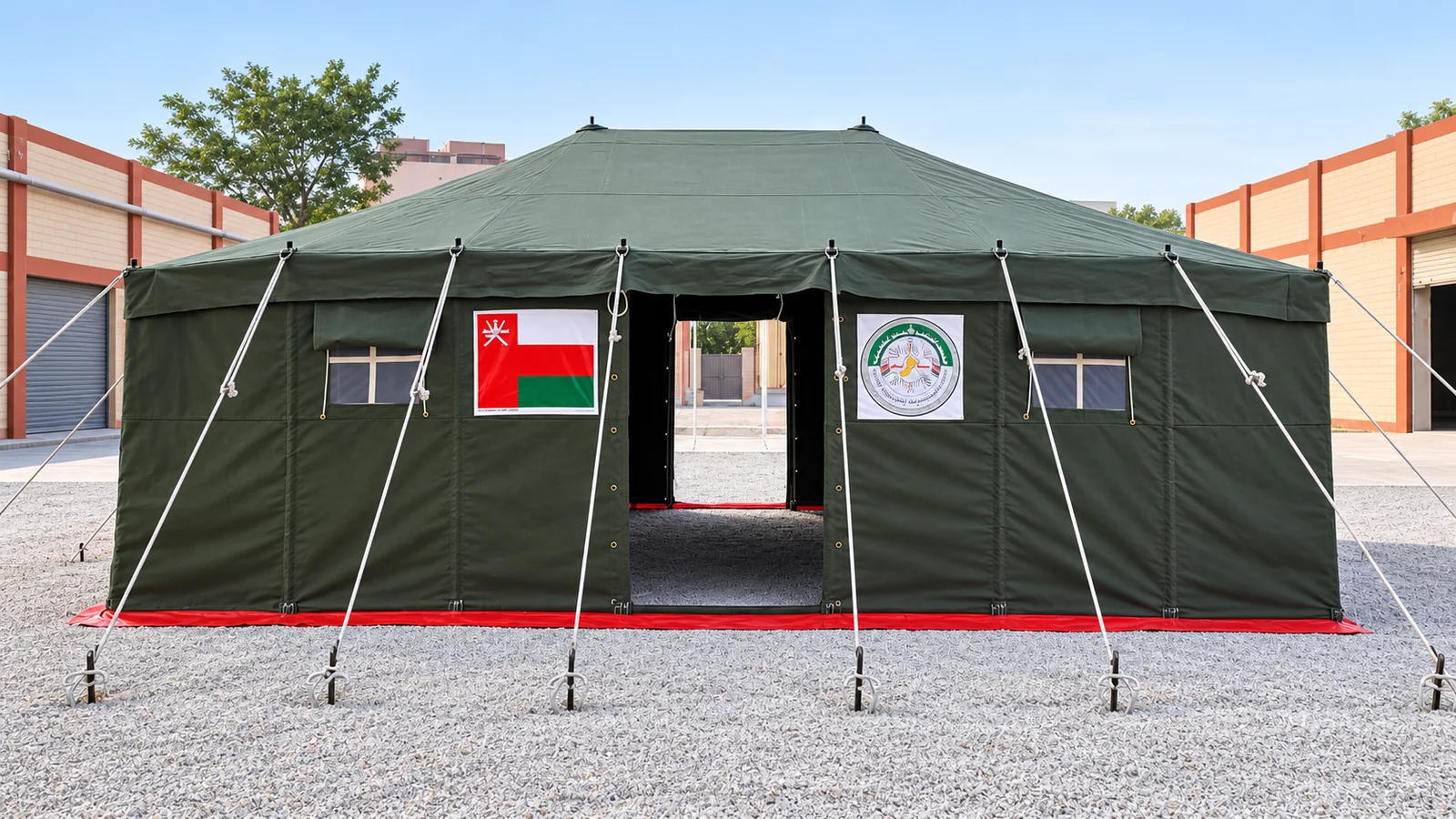 Front view of an olive-green humanitarian relief tent with framed entrance, windows and guy ropes